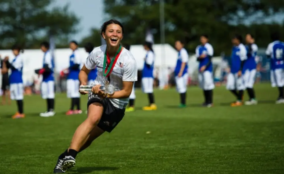 Lyra Olson â16 accepts the team spirit trophy for the United States at Julyâs World Under-23 Ultimate Championships. (Ultiphotos/Kevin Leclaire)