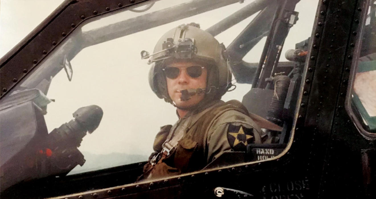 Christopher Hornbarger in military flight uniform piloting a helicopter
