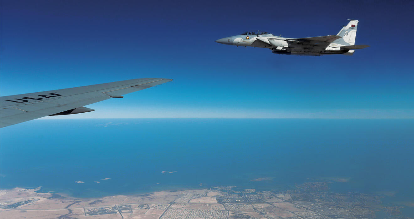 An F-15QA, right, flies in formation with a U.S. plane during exercises over Qatar in January. 