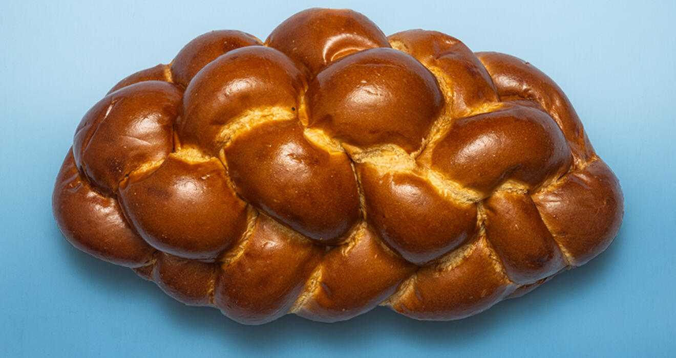 Challa bread on blue background