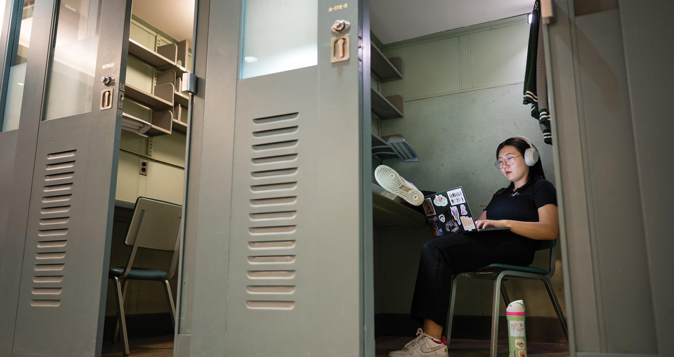 PAW’s Grace Ni ’23 puts a modern spin on the senior thesis process in a 3-by-8 metal carrel. Most carrels were removed in 2012, but three remain available to students at Firestone Library.