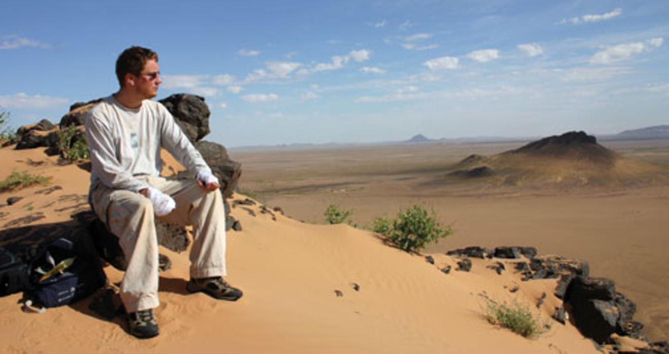 Iain Couzin in Mauritania, where he was studying locusts. His hands are bandged because a toxin from the locusts got on his skin and reacted to sunlight, causing pain.
