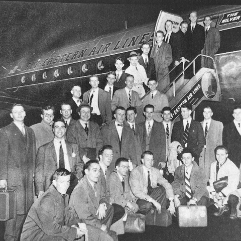 Glee Club members circa 1952 pose outside an Eastern Airlines plane