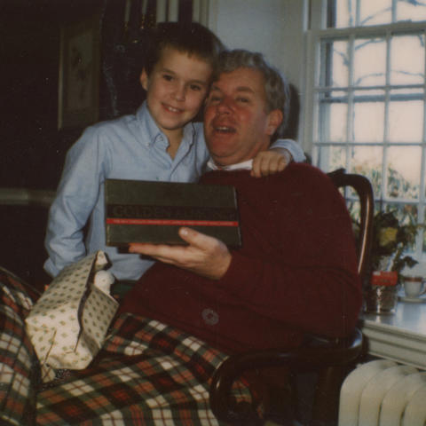 StephenLamberton1.jpg A boy wraps his arm around his dad's neck as both pose for a photo.