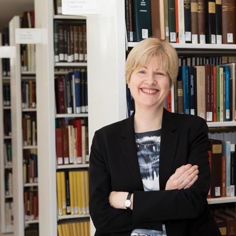 Dean of Libraries Anne Jarvis standing in the stacks at Firestone Library