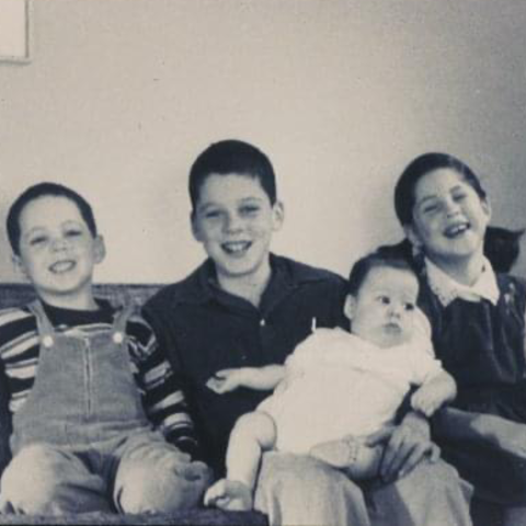 Four children seated on a couch