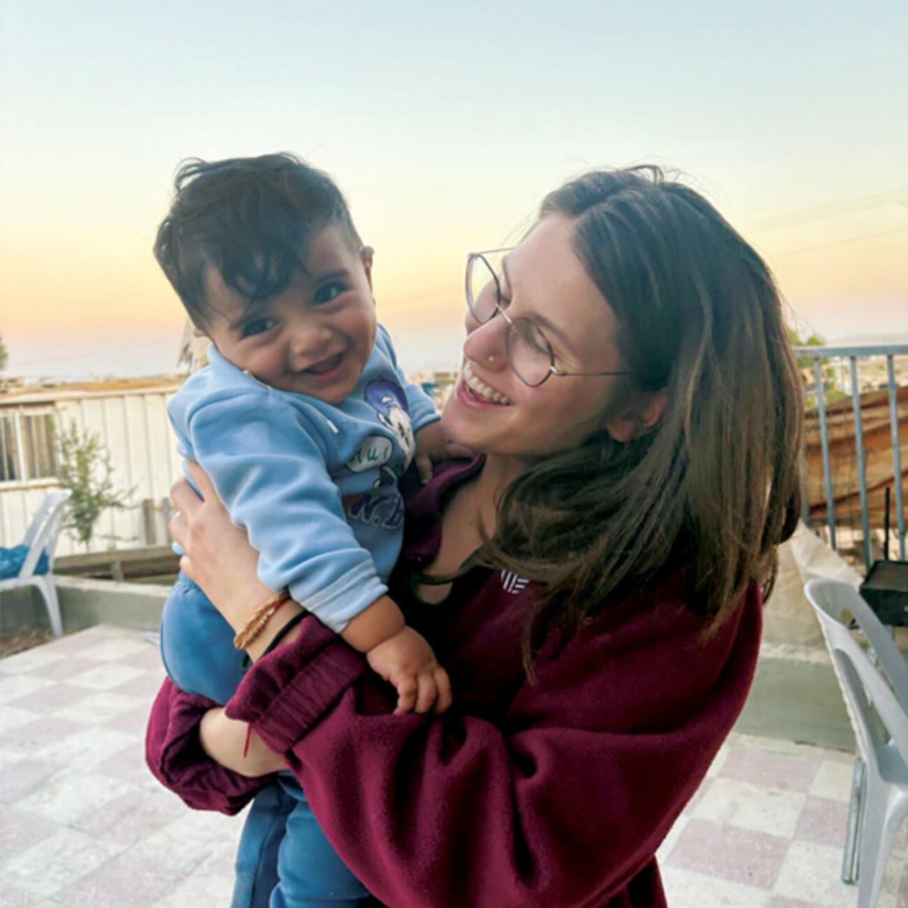 JEWISH_Emanuelle Sippy.jpg Emanuelle Sippy ’25, shown in a village in the West Bank in 2025, holds the son of Awdah Hathaleen, a Palestinian activist who was killed by an Israeli settler in 2025.