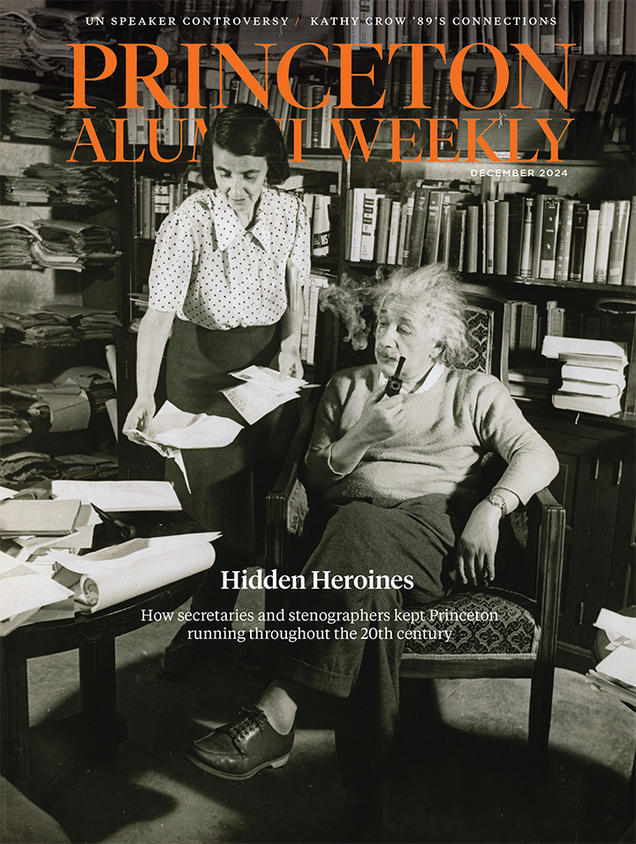 The cover of PAW’s December, 2024, issue, featuring a photo of Albert Einstein in a book-filled office with his secretary, Helen Dukas.