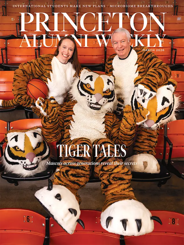 Three people in tiger mascot costumes sit on orange stadium seats. 
