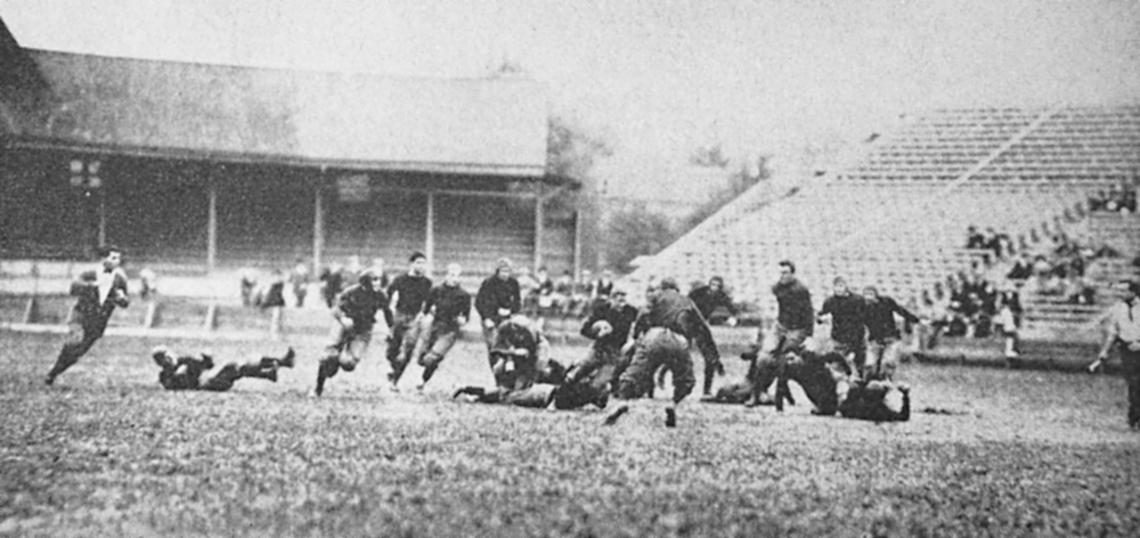 Black and white photo of Hobey Baker and his team on the field playing football.