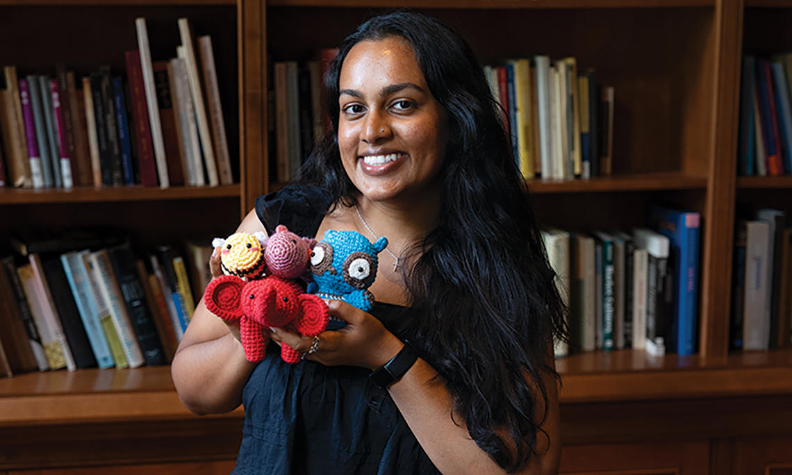 Julianne Somar ’26 shows off some of the nontraditional items in the emergency go-bag the team designed.