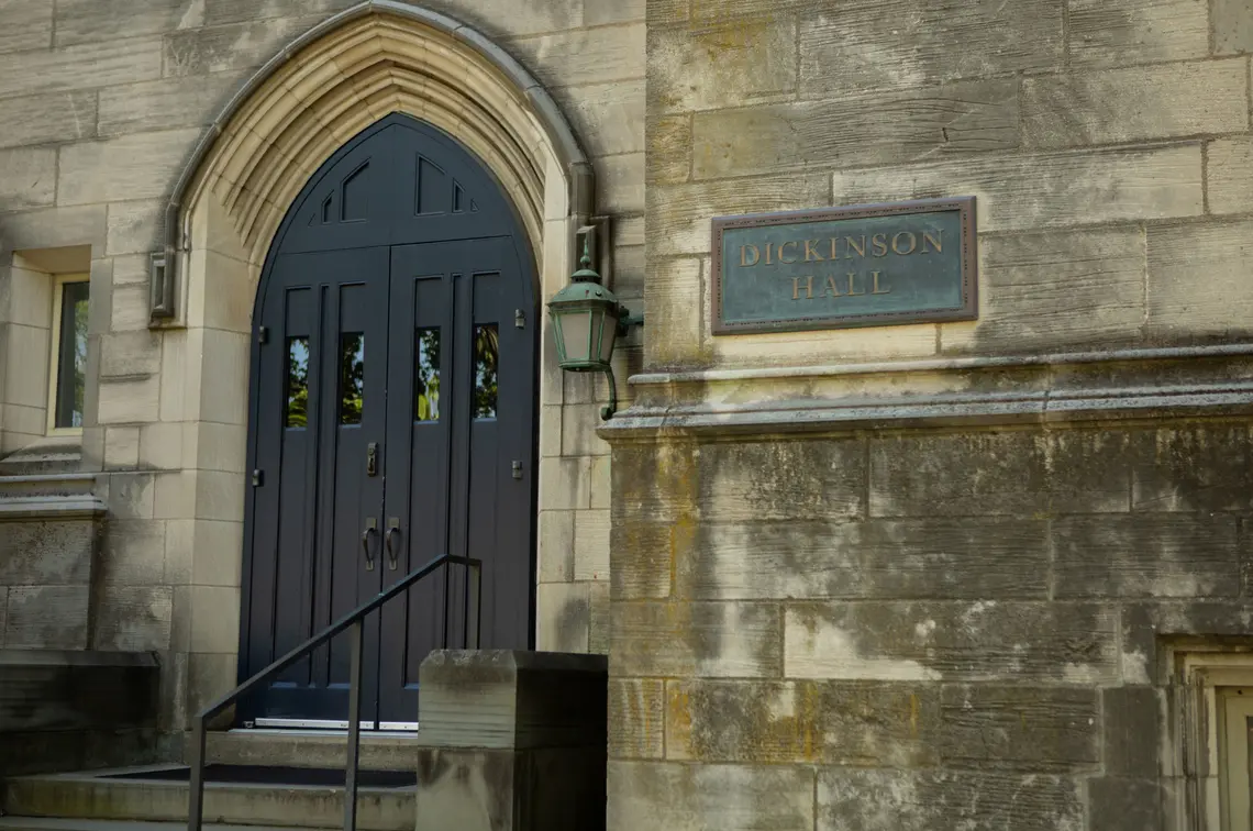 20190627_CL_JBS_024.jpg A door on a Gothic building next to a sign reading "Dickinson Hall."