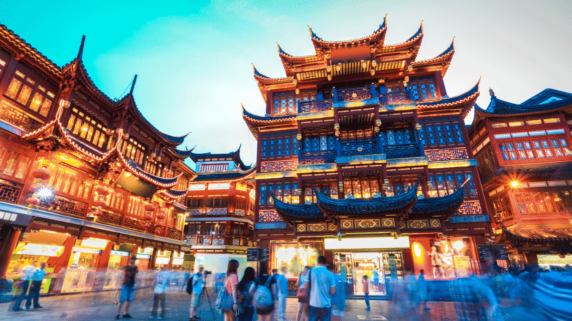 Photo of the Yuyuan Garden in Shanghai, China with people surrounding it 