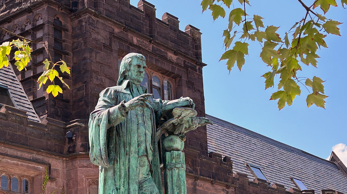 Statue of John Witherspoon with East Pyne Hall in the background