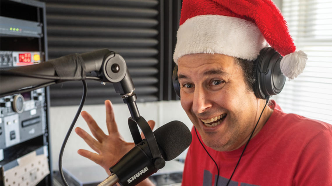 Jon Solomon in Santa Claus hat behind the mic int he WPRB studio