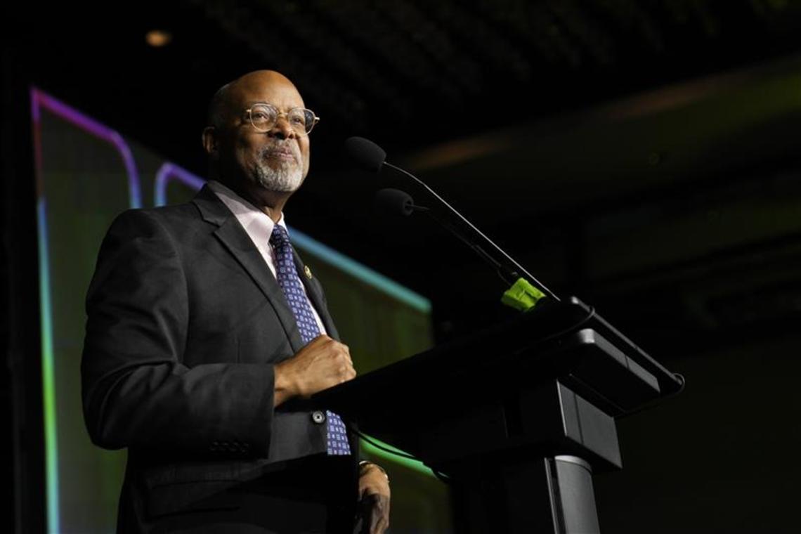 Rep. Glenn Ivey stand at a podium during election night. 