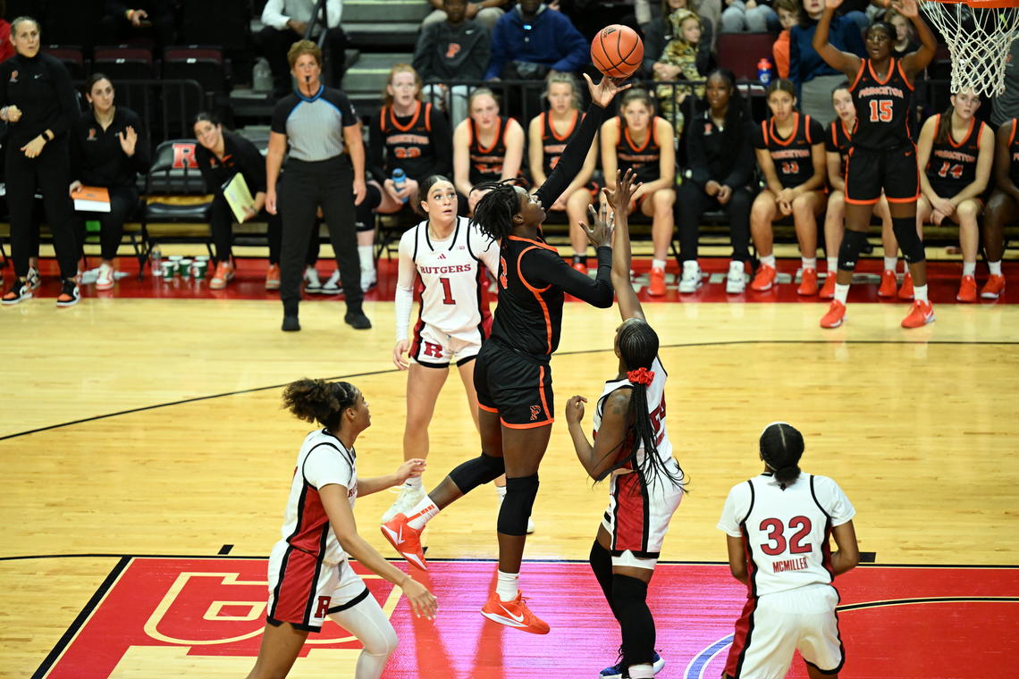 A Princeton basketball player launches the ball toward the basket from the paint.
