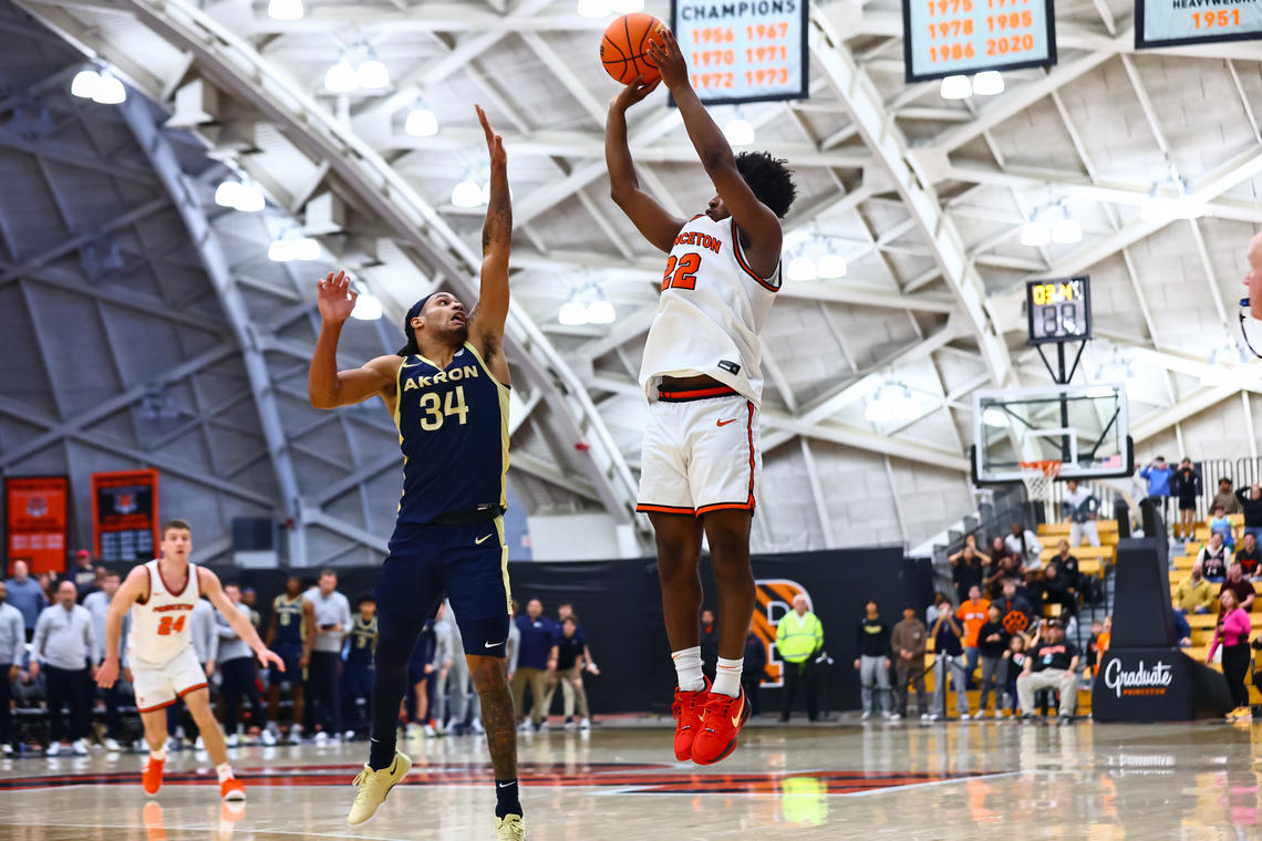 24_Dalen_Davis_ActionMBB_20241230-0732 (1).jpg Princeton basketball player Dalen Davis '27, jumps while preparing to shoot a three. A player from Akron is jumping in front of him, attempting to block the shot.