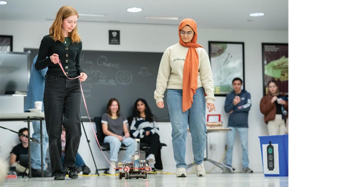 Caroline Rasmussen ’26, left, and Yushra Guffer ’26 present their Car Lab vehicle at the end of the semester,  a tradition that began in  the 1990s