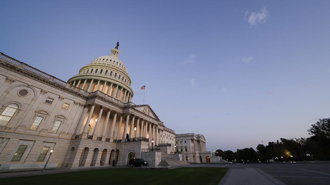 The U.S. Capitol, photographed from an angle at dusk.