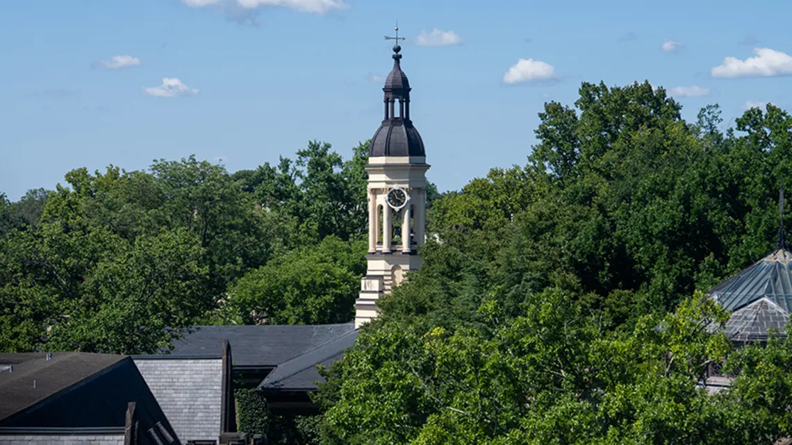 20240822_FirestoneLibrary_MR_055.jpg The cupola of Princeton's Nassau Hall peeks up from surrounding leafy trees.