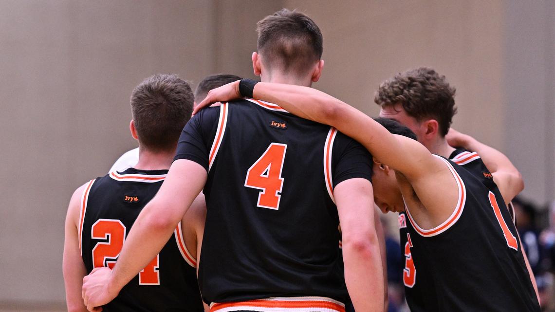 Princeton men’s basketball in a huddle.