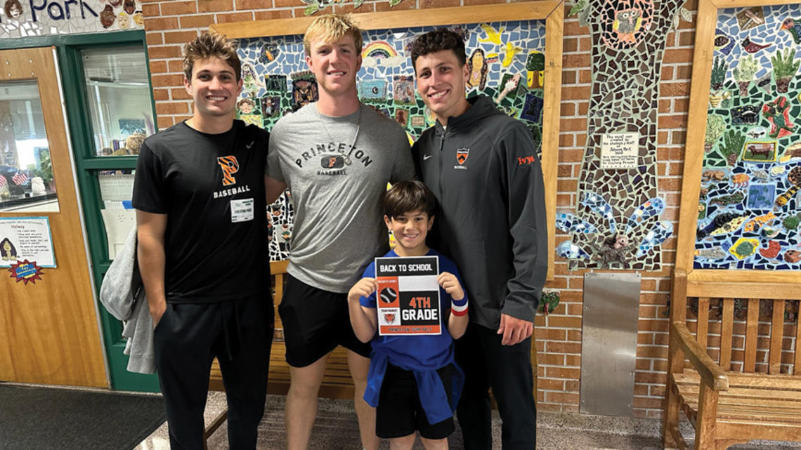 Baseball players, from left, Grant Werdesheim ’28, Jake Kernodle ’27, and Andrew D’Alessio ’25 catch up with a fourth-grader at Johnson Park Elementary.