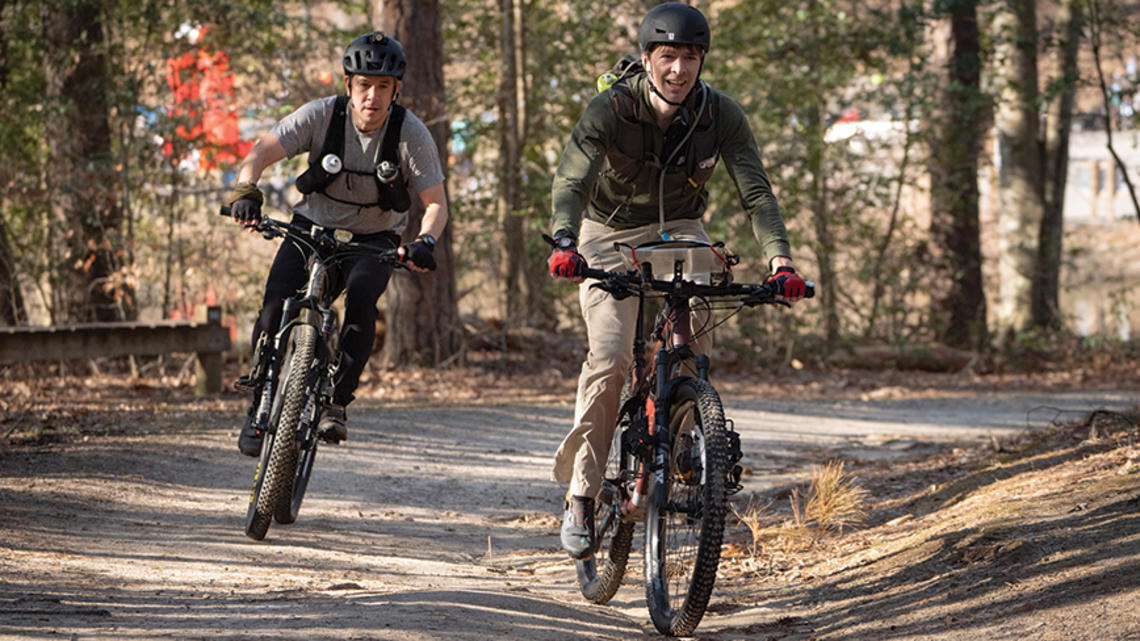 PRINCE_adventureracers_1.jpg Two men ride bicycles.