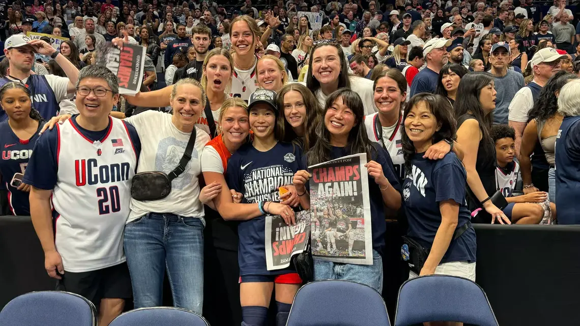 chen-princeton-athletics.png Kaitlyn Chen ’24, center, celebrates Connecticut’s national championship with family and friends, including Princeton head coach Carla Berube.