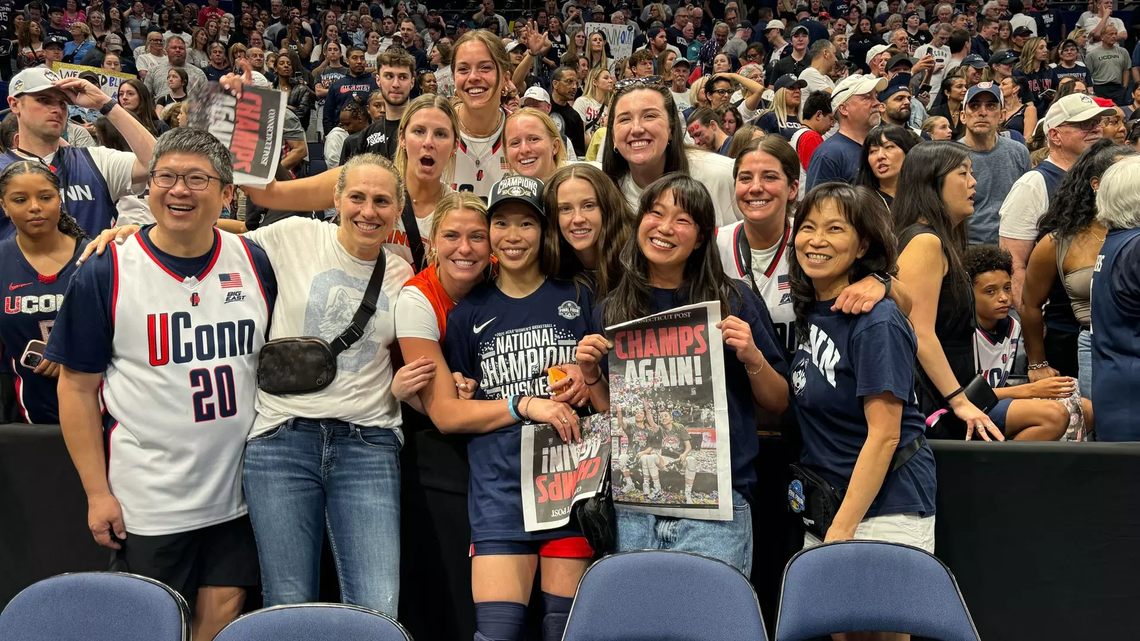 chen-princeton-athletics.png Kaitlyn Chen ’24, center, celebrates Connecticut’s national championship with family and friends, including Princeton head coach Carla Berube.