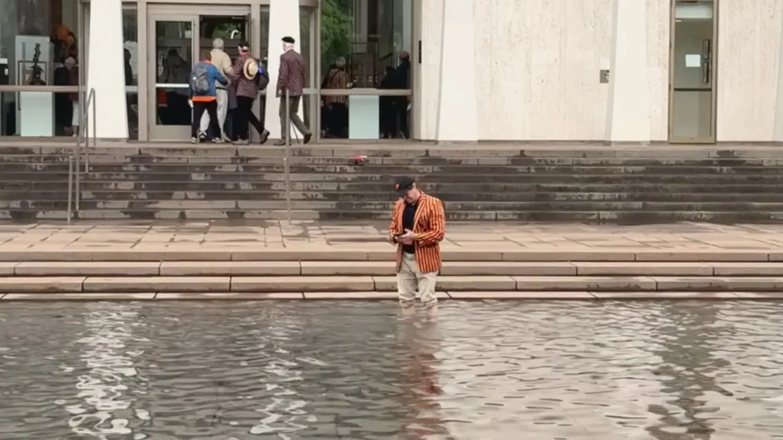 MARK VIDEO_Standing in Freedom Fountain.jpg PAW writer Mark F. Bernstein '83 stands in the reflecting pool of the Fountain of Freedom