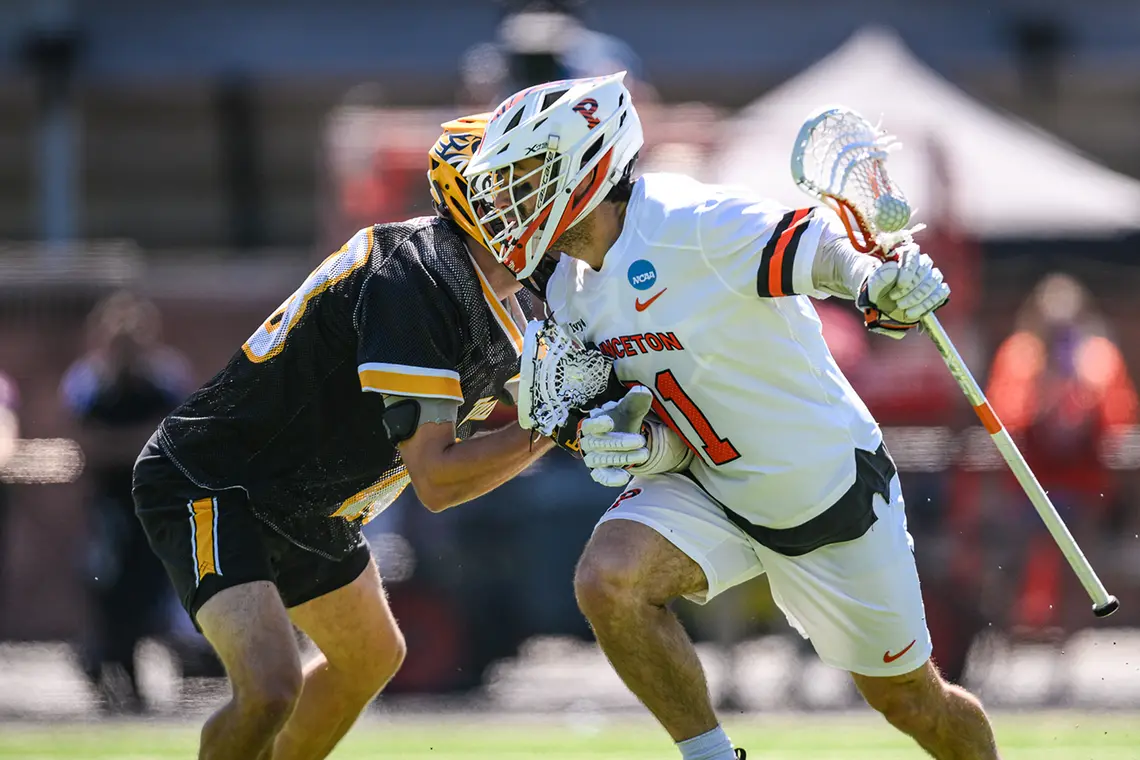Coulter Mackesy cradles the ball in his stick as he tries to get past a defender
