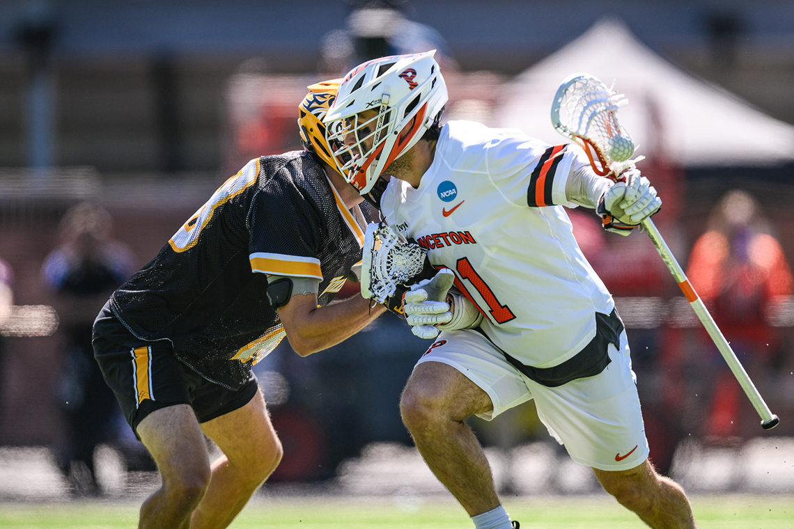 Mackesy_creditKarlaDonohoe-PrincetonAthletics.png Coulter Mackesy cradles the ball in his stick as he tries to get past a defender