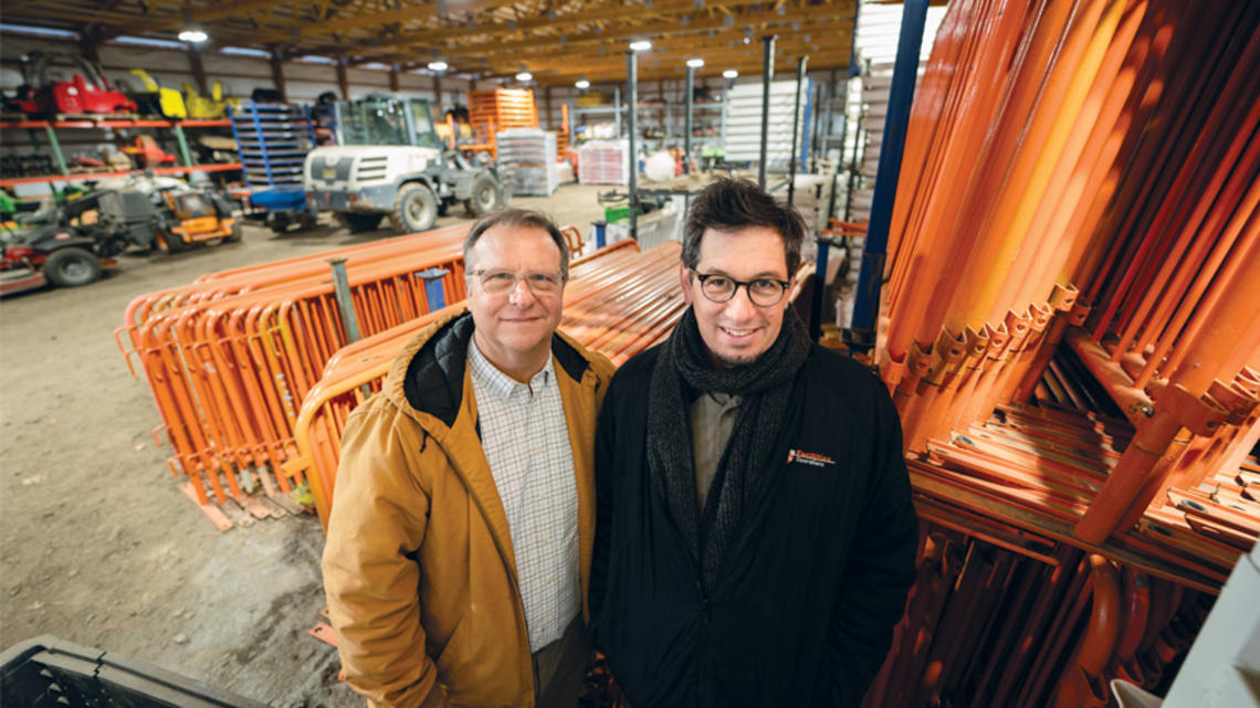 RG_Staff 1.jpg Devin Livi, director of campus grounds, left, and Robert Staudt, assistant director of campus grounds stand in the the storage area for much of the Reunions hardware such as fending, electrial wires, etc.