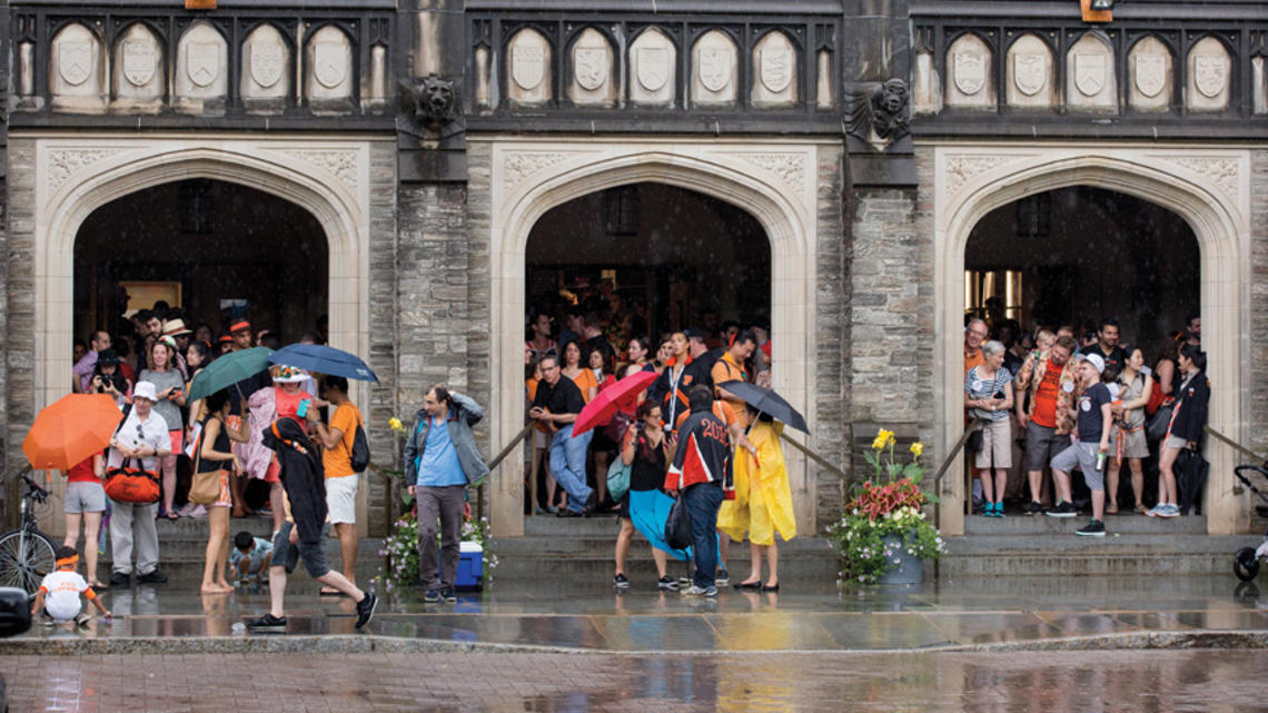 RG_Weather.jpg Reuners standing under the portico at Firestone Lirary to escape the rain during the 2018 P-rade