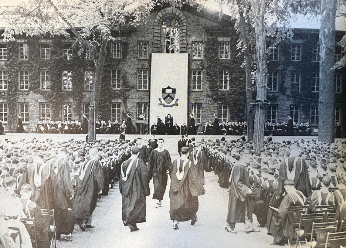A black-and-white photo of commencement in front of Nassau Hall.