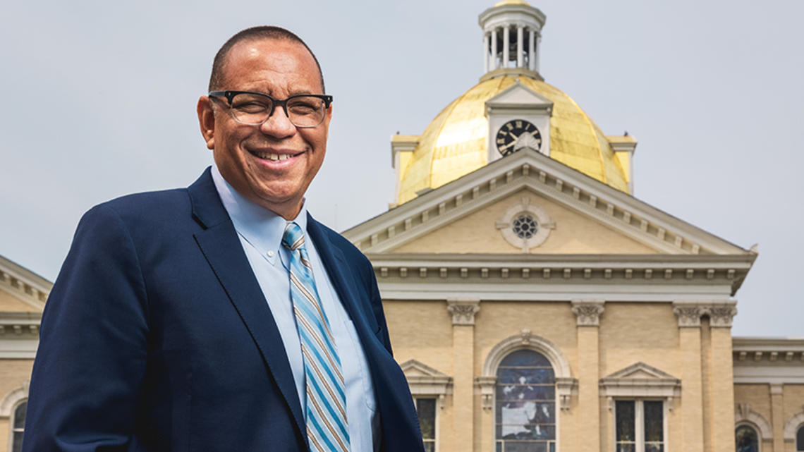 Dale Caldwell ’82 in front of a building with a gold dome at Centenary University.