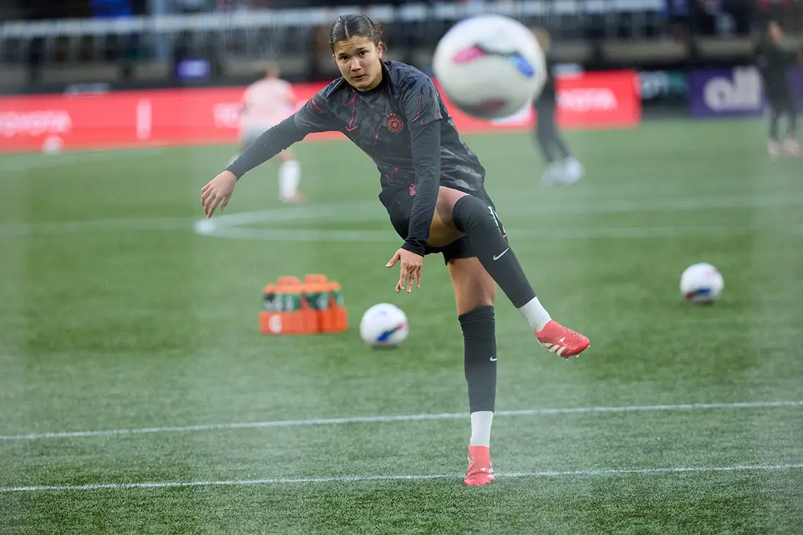 Thorns.vs_.AngelCityFC.032125.FW128_1320.jpg Pietra Tordin follows through on a right-footed shot, with a soccer ball in the air in foreground