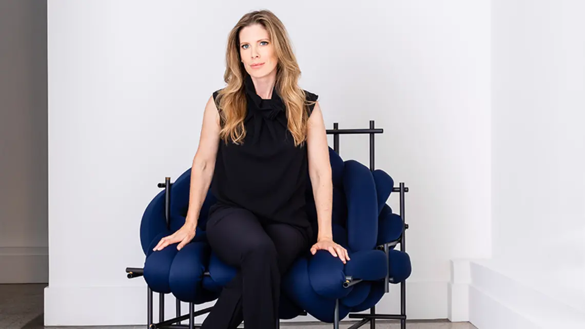 Amanda Pratt ’01 sits in a blue chair.