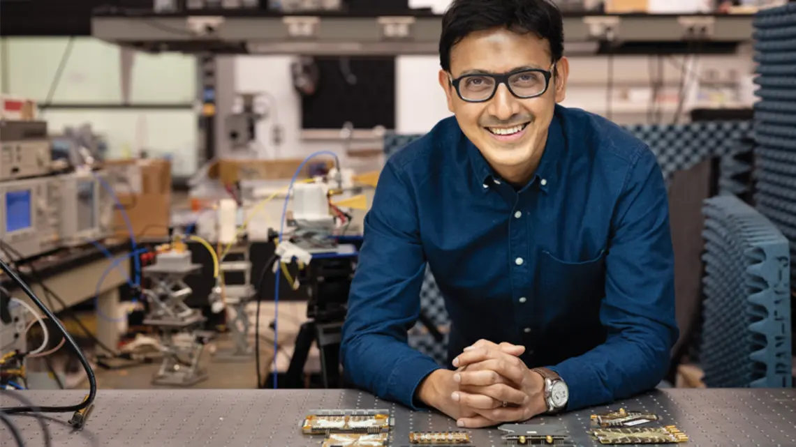 Kaushik Sengupta in what looks like an electrical engineering lab.
