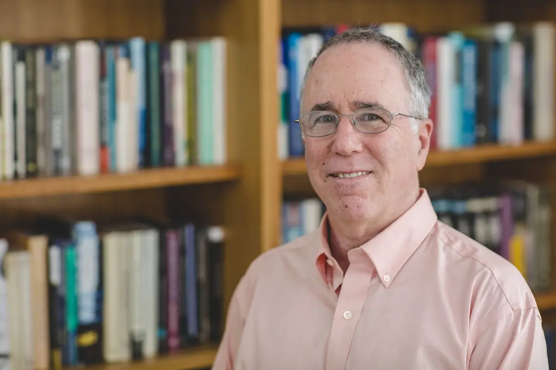 20170808_GeneGrossman_FacultyPortrait_CF_0001.jpg This is a shoulders-and-up photo of Gene M. Grossman with a bookcase in the background.