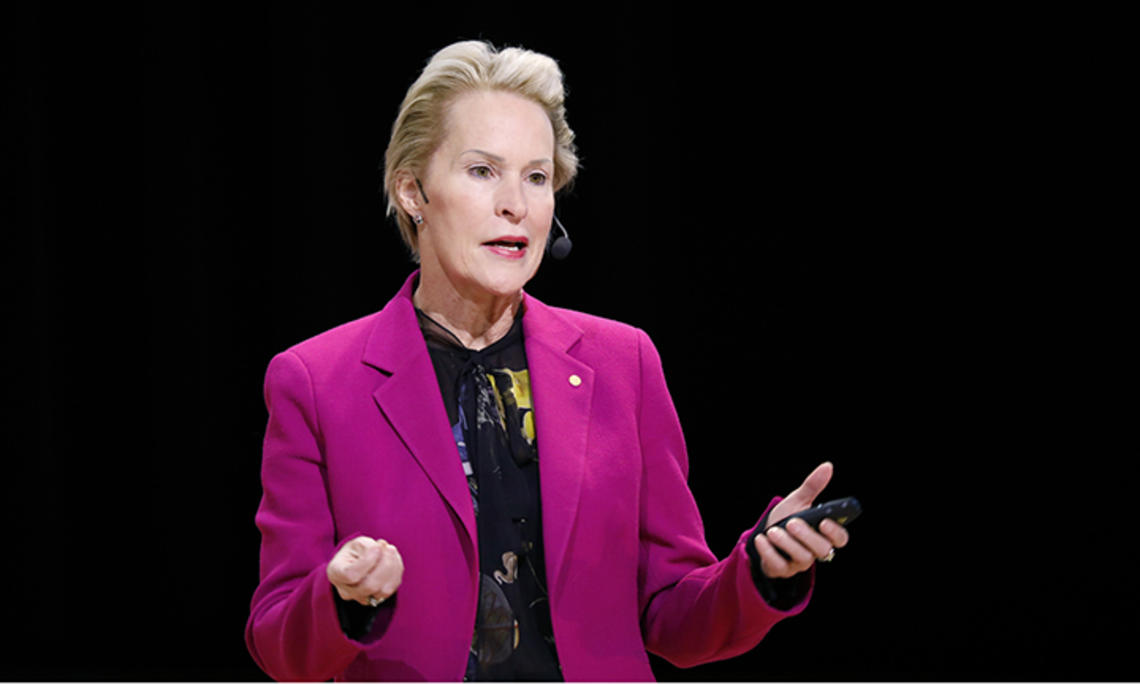 This is a photo of Frances Arnold ’79 speaking at a podium.