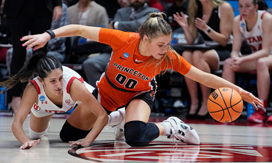 Princeton forward Ellie Mitchell ’24 stretches for a loose ball next to Utah guard Ines Vieira.