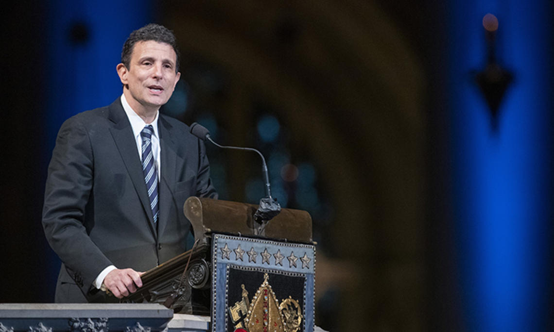 This is a photo of David Remnick speaking at a podium.