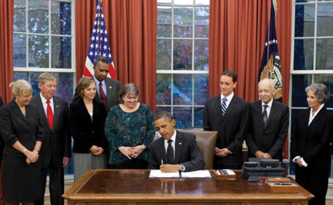 First Response Action board member and legislative liaison Kate Finn ’06, third from left, at the White House as President Obama signs the Kate Puzey Peace Corps Volunteer Protection Act of 2011 into law Nov. 21.