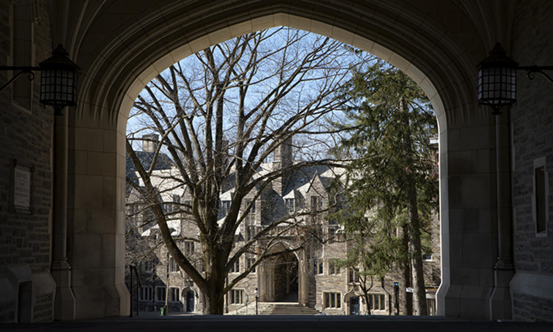 This is a photo of a gothic campus building viewed through an archway.