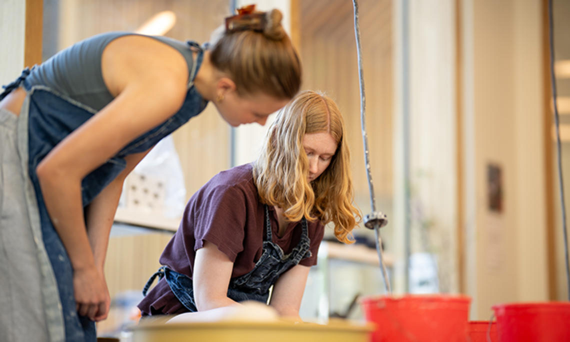 Two women work in the ceramics studio.