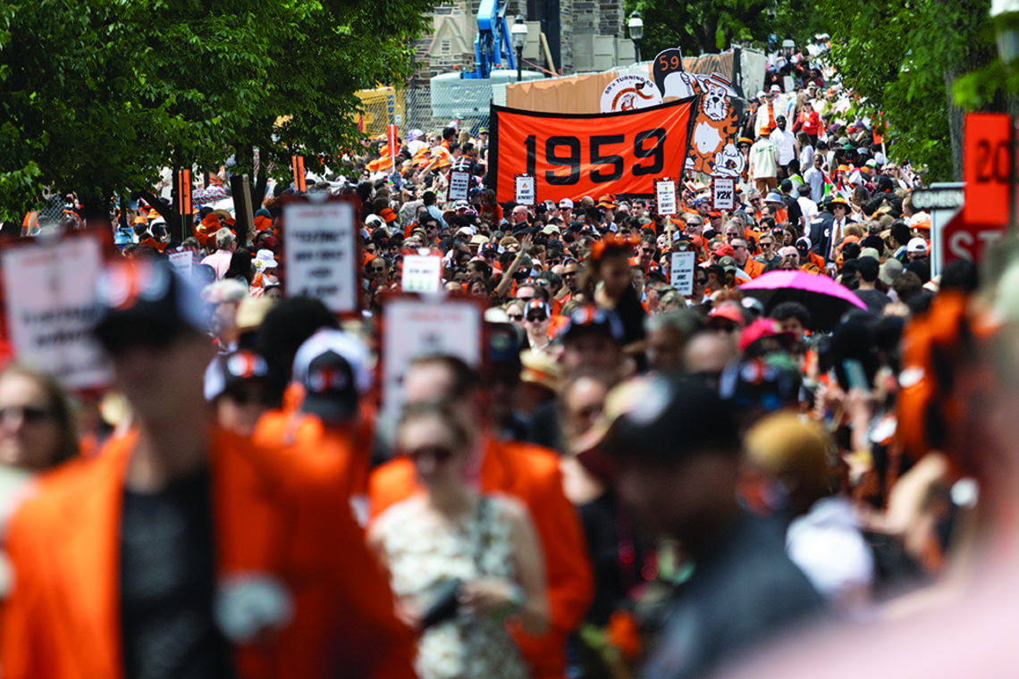 A sign reading 1959 rises above the crowd at the P-rade.