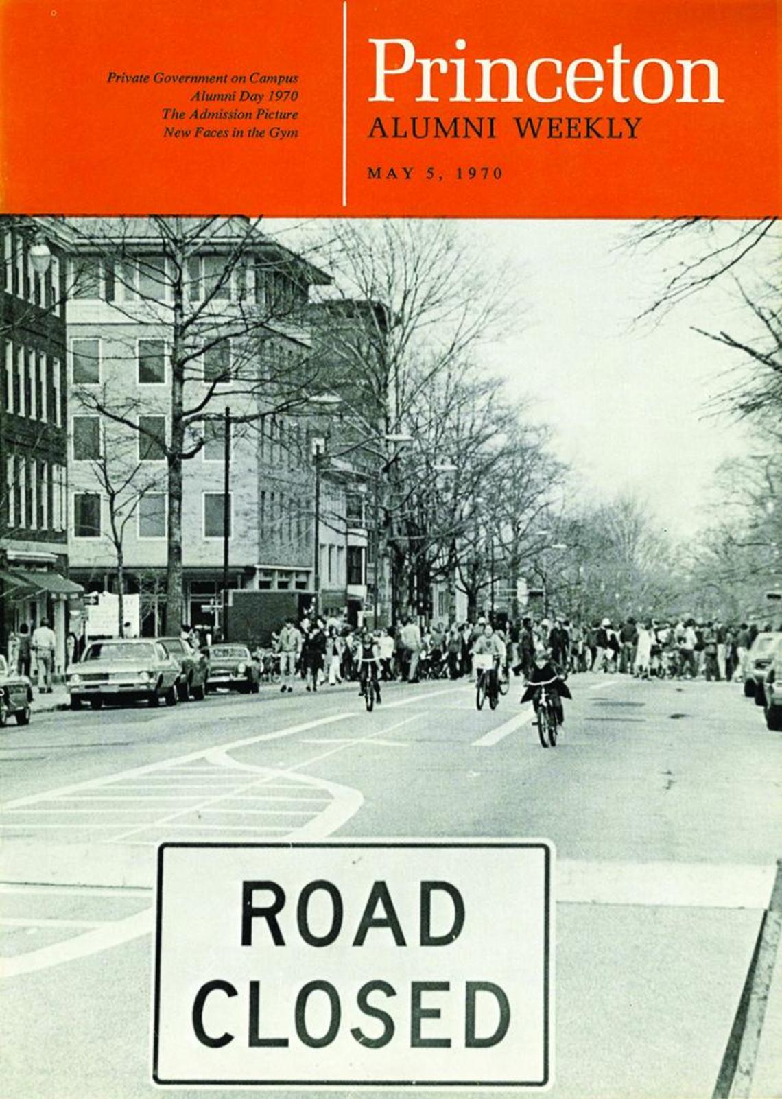 A black-and-white photo on the cover of PAW showing people bicycling down Nassau Street and a sign reading "Road Closed."