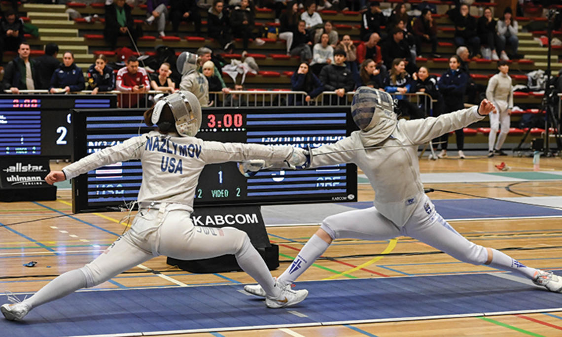 Two people fencing.